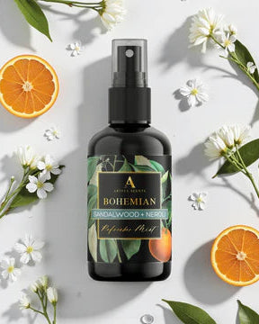 Bohemian Sandalwood & Neroli diffuser bottle with oranges and flowers on a light background