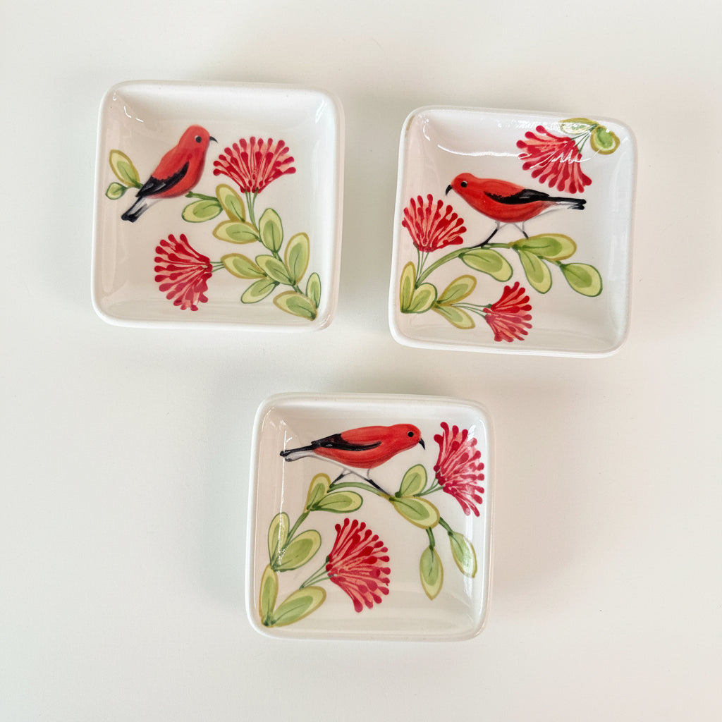 Three square ceramic plates with bird and flower designs