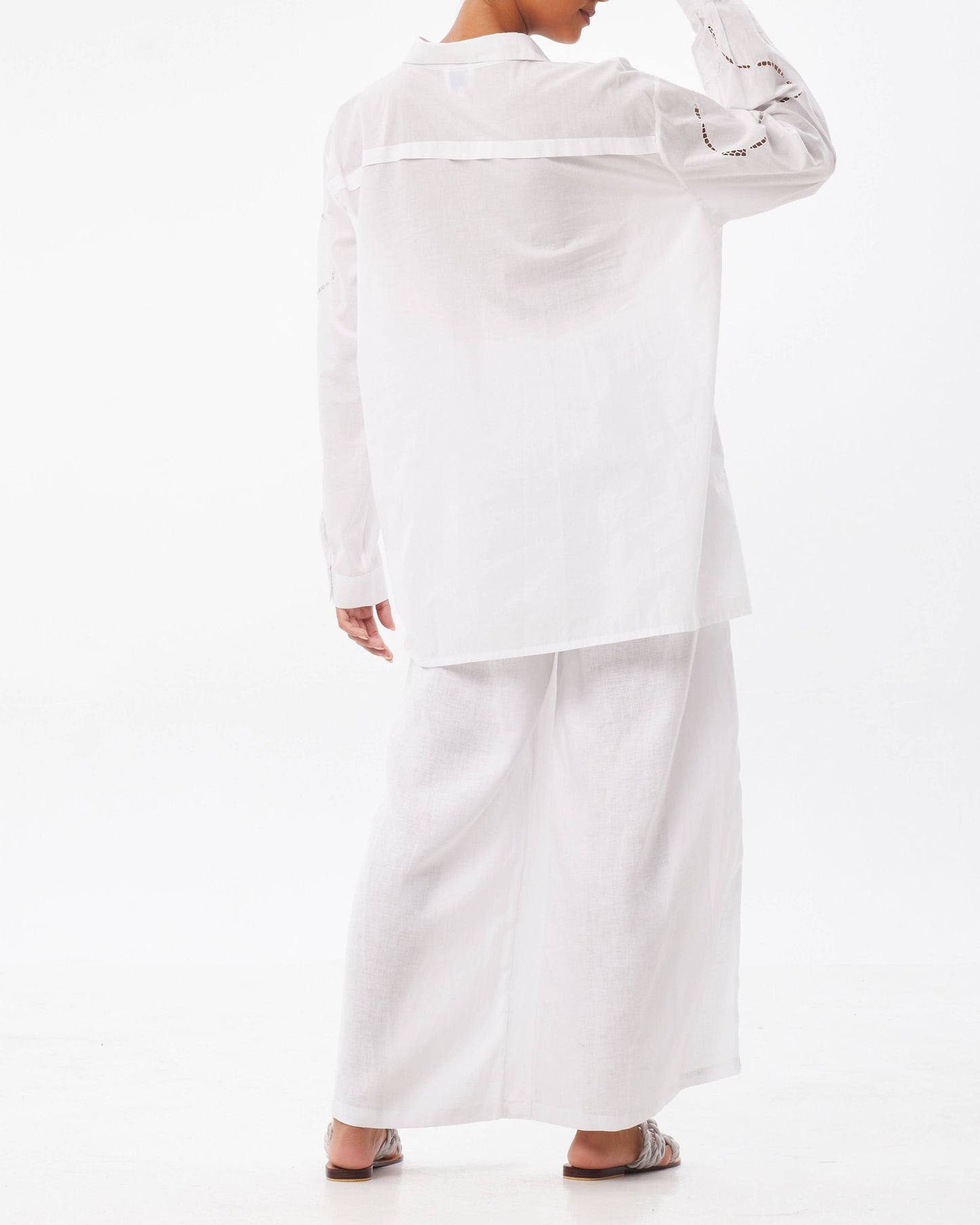 Person wearing a white outfit on a white background