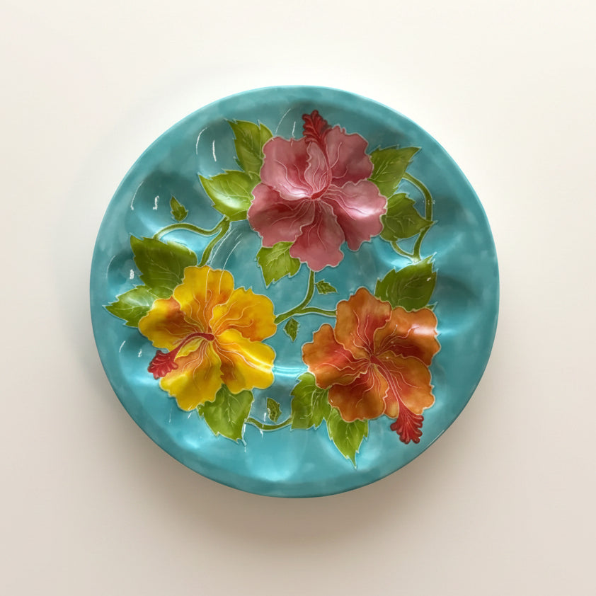Decorative plate with colorful floral design on a light blue background