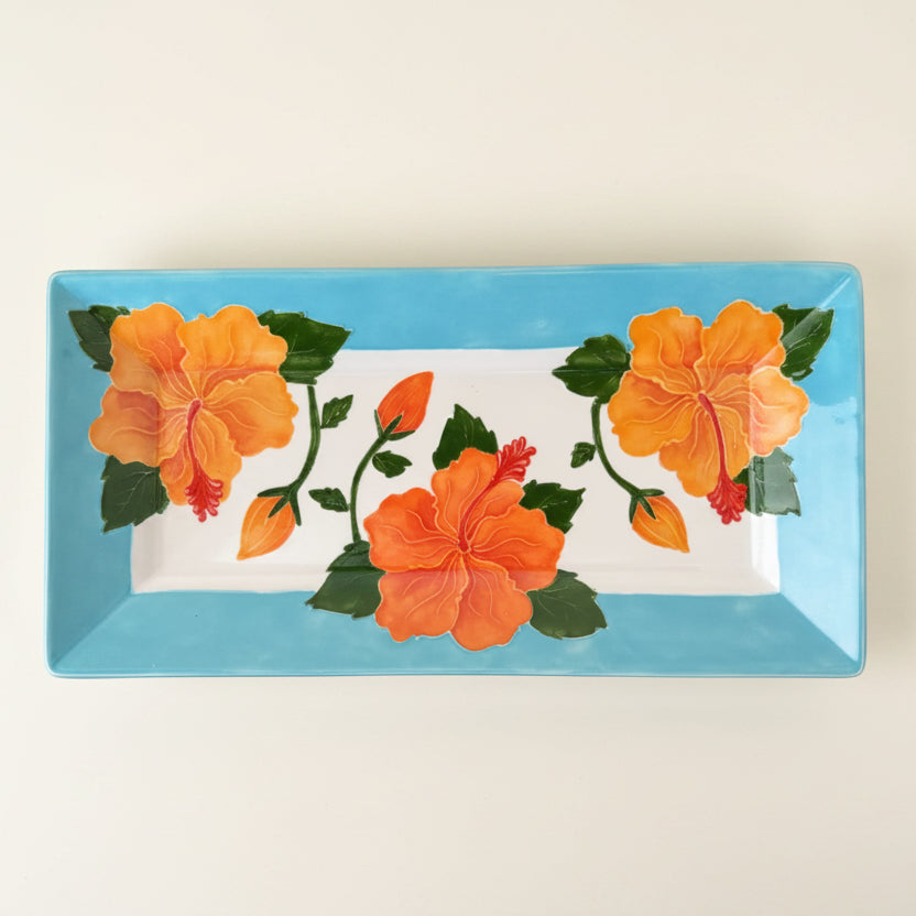 Decorative tray with floral design on a blue background