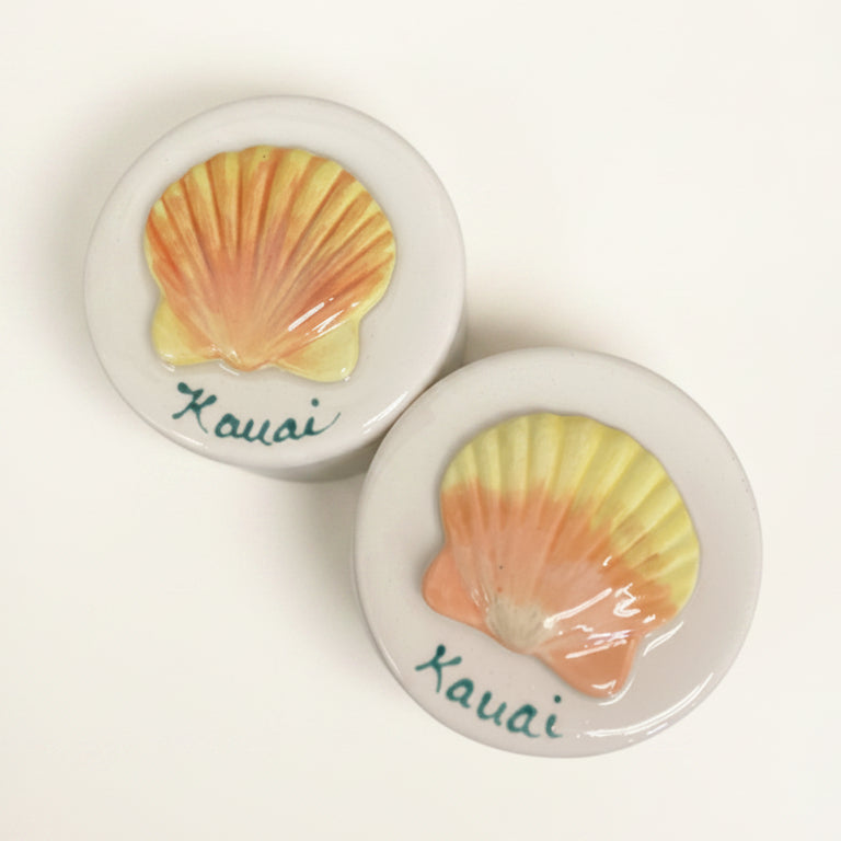 Pair of shell-shaped earrings with 'Kauai' text on a white background