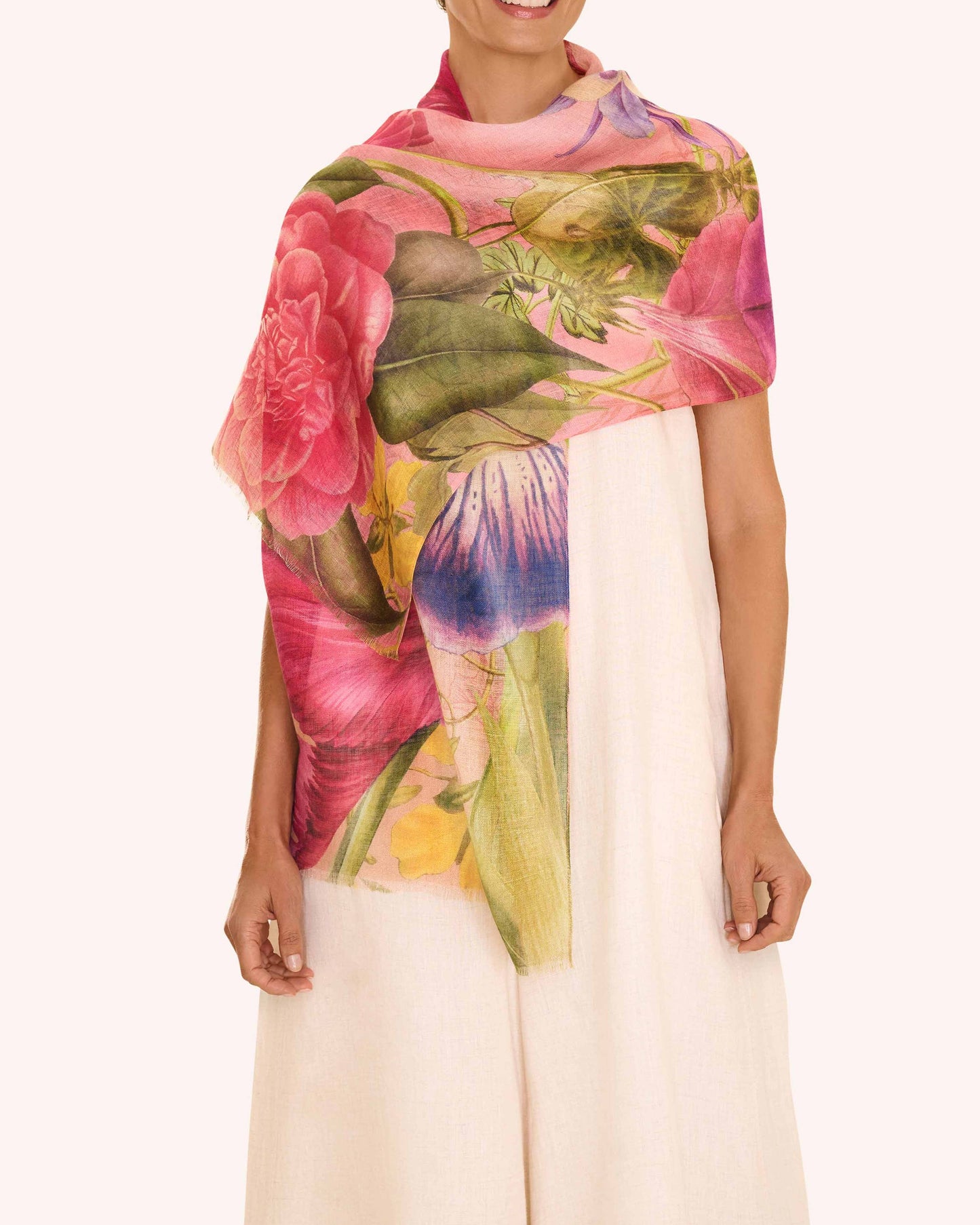 Woman wearing a colorful floral scarf on a white background