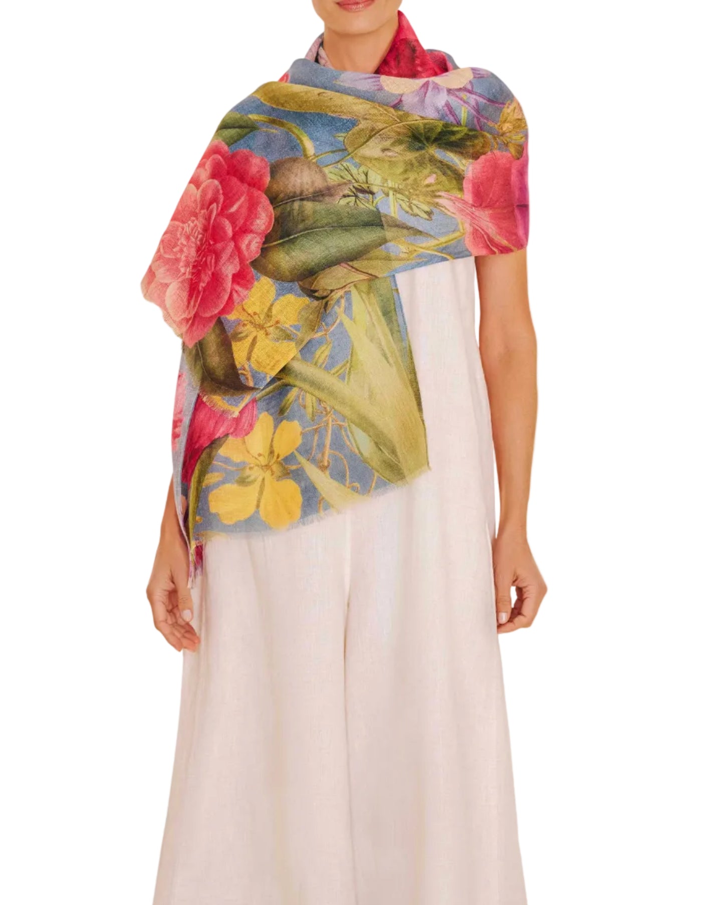 Woman wearing a colorful floral scarf on a white background