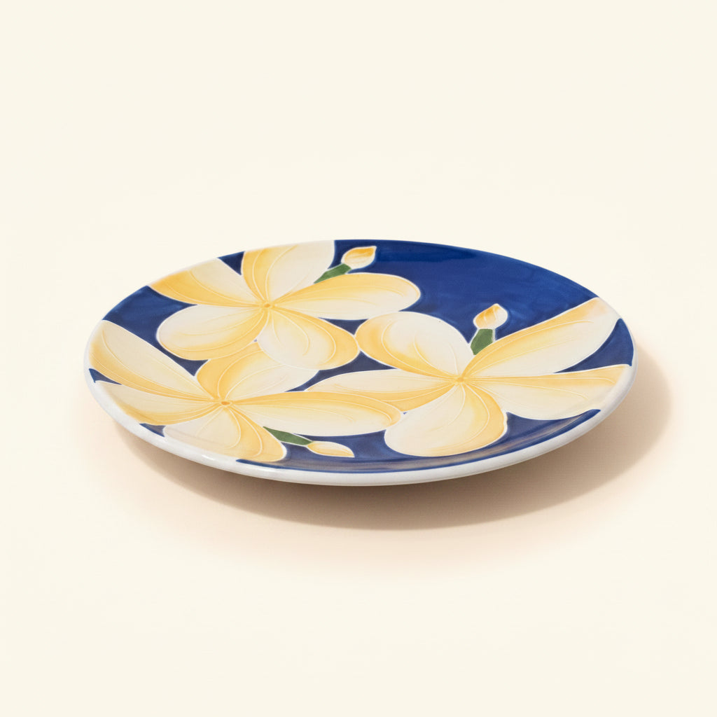 Ceramic plate with yellow floral design on a blue background