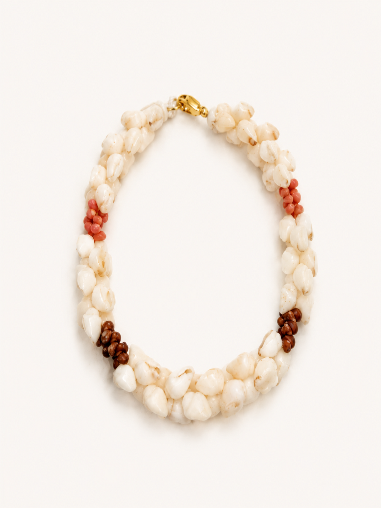 Beaded bracelet with white, brown, and red shells on a white background