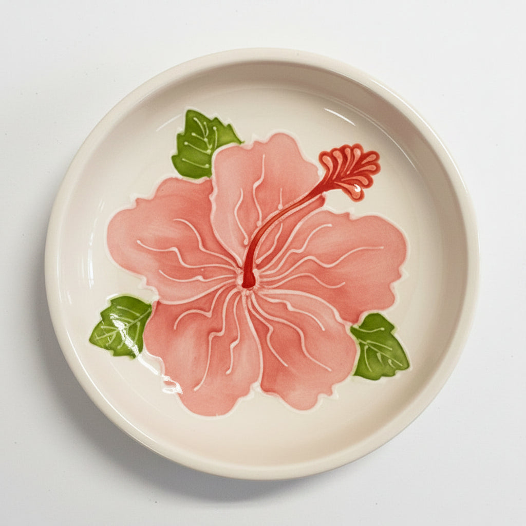 Ceramic plate with a pink floral design on a white background