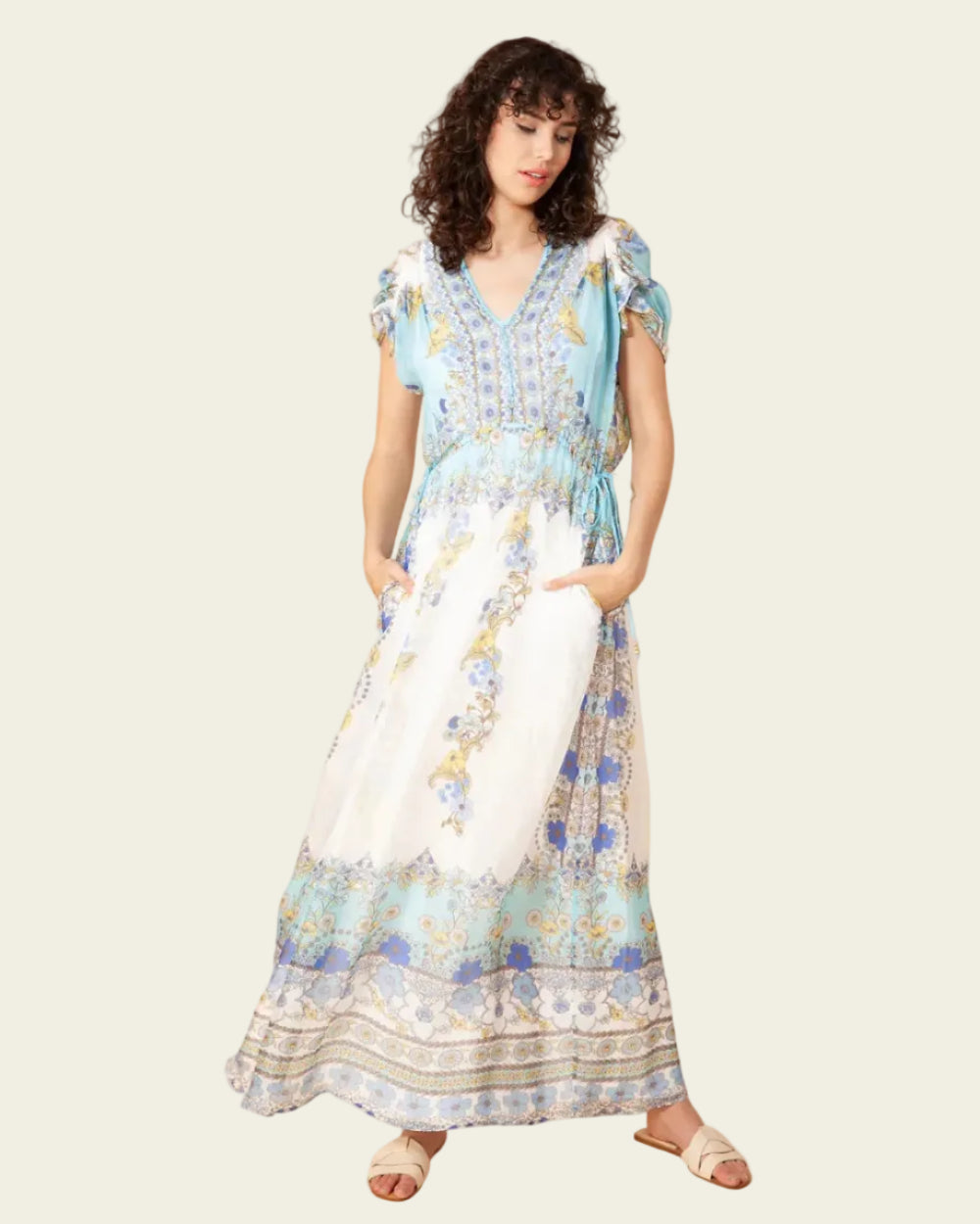 Woman wearing a floral dress against a plain background