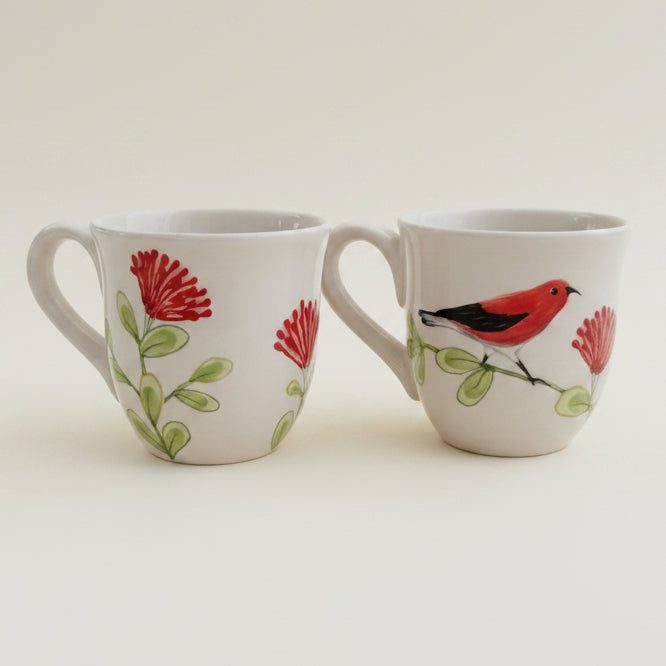 Two ceramic mugs with bird and flower designs