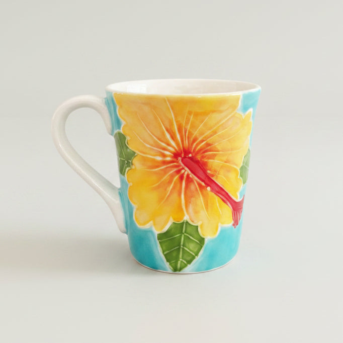 Mug with a colorful hibiscus flower design on a white background