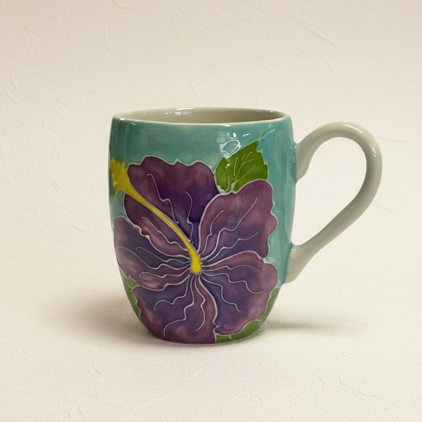 Ceramic mug with a purple flower design on a white background