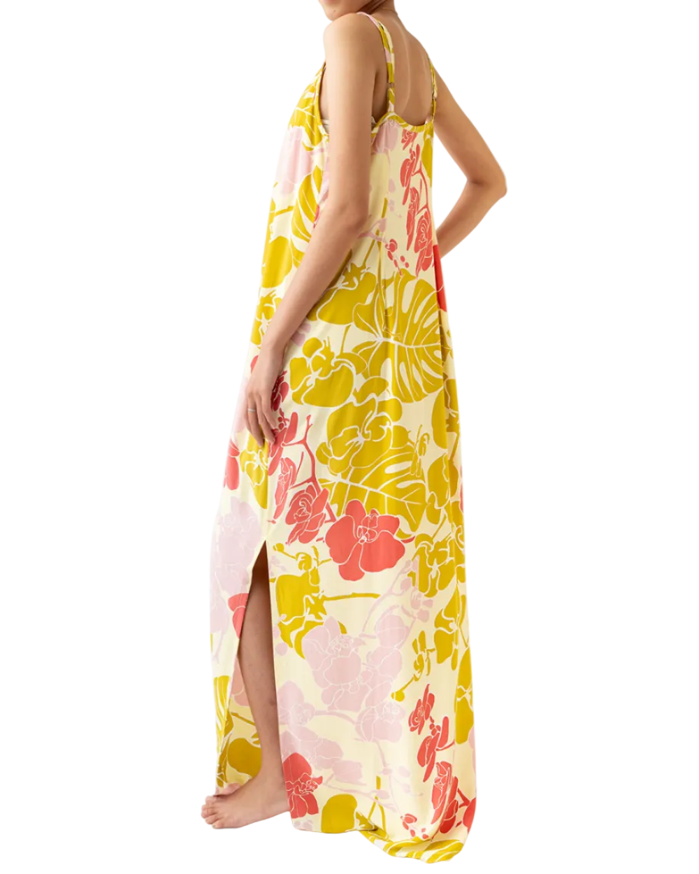Woman wearing a colorful floral dress on a white background