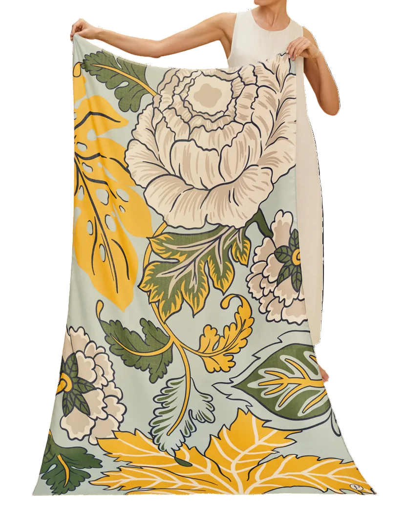 Woman holding a floral patterned fabric with large flowers and leaves.