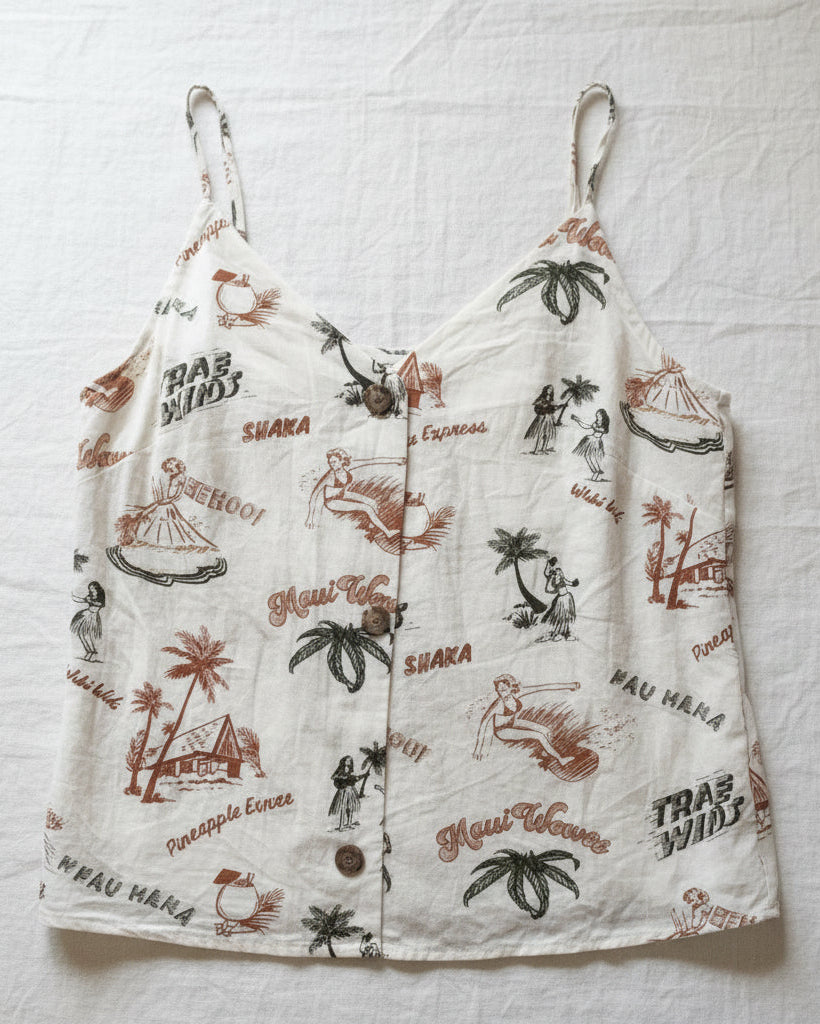 White top with tropical pattern on a white fabric background