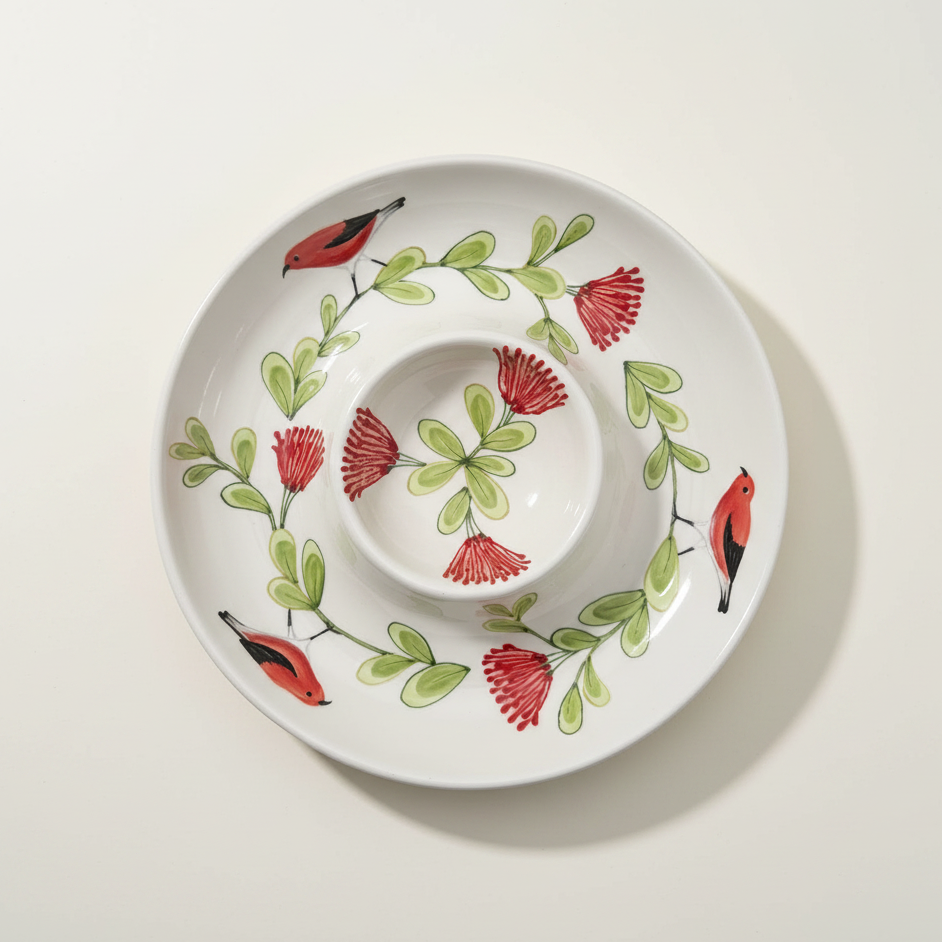 Decorative chip and dip platter with red flowers and birds on a beige fabric background