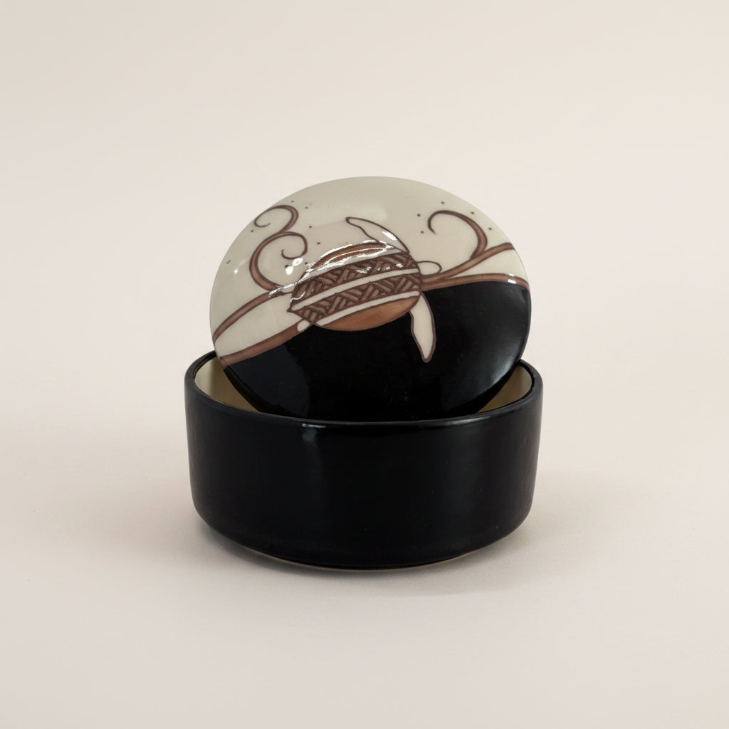 Treasure Box with a black base and beige top on a light gray background