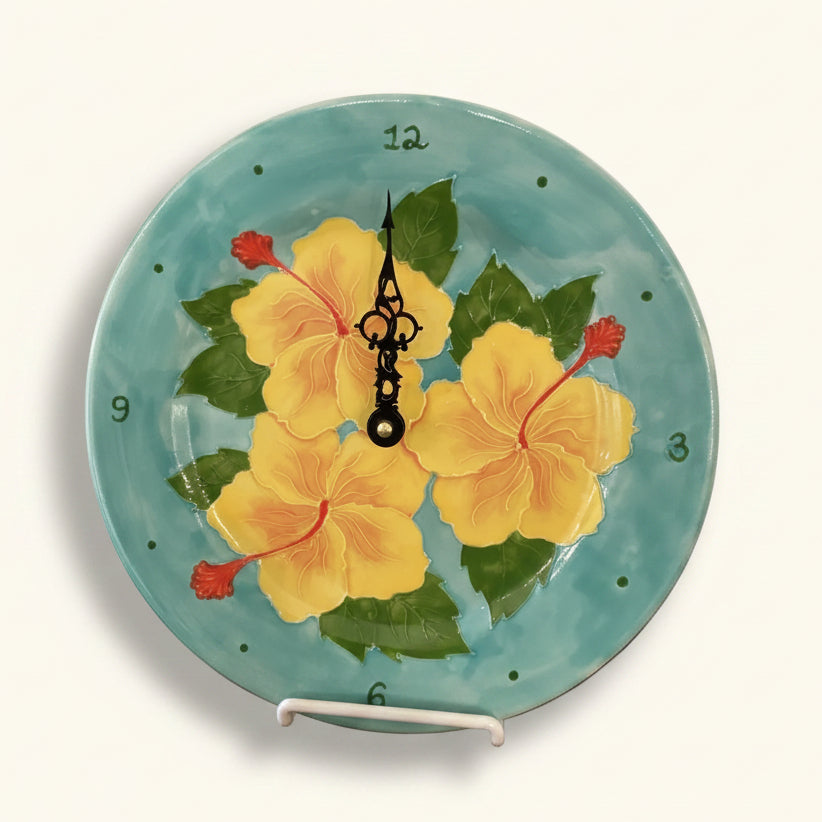 Decorative plate with yellow flowers and a clock design on a turquoise background