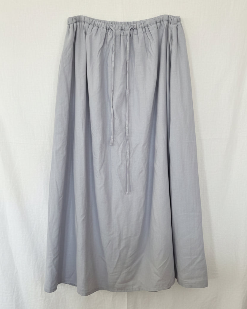 Gray skirt on a hanger against a white background