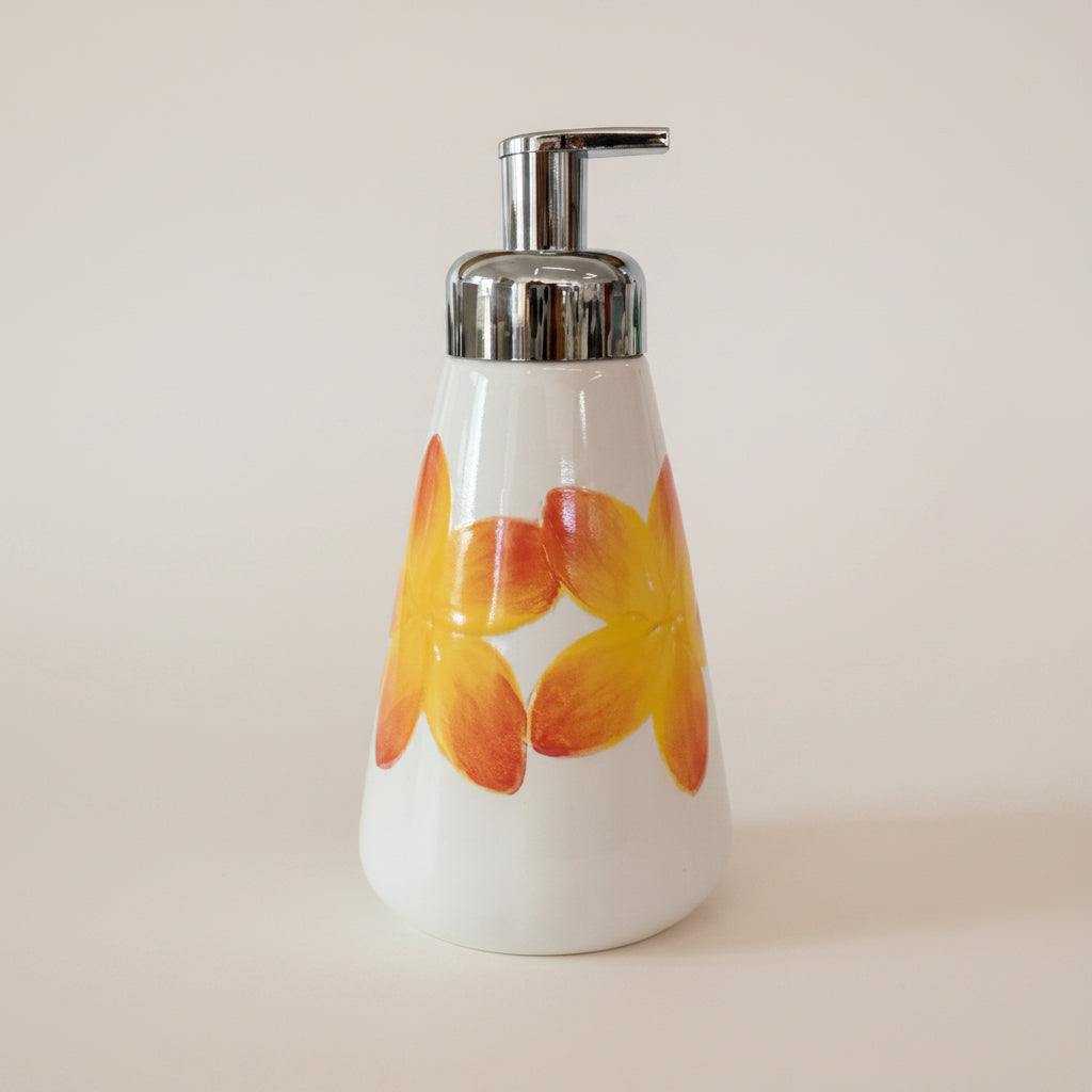 Soap dispenser with floral design on a white background
