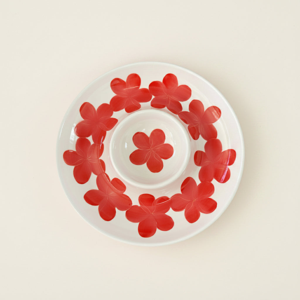 White chips and dip platter with red floral patterns on a white background