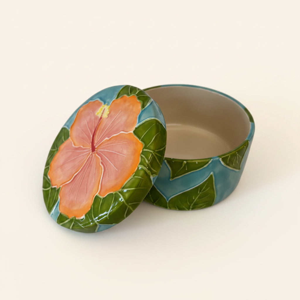 Decorative tin with a floral design on a white background
