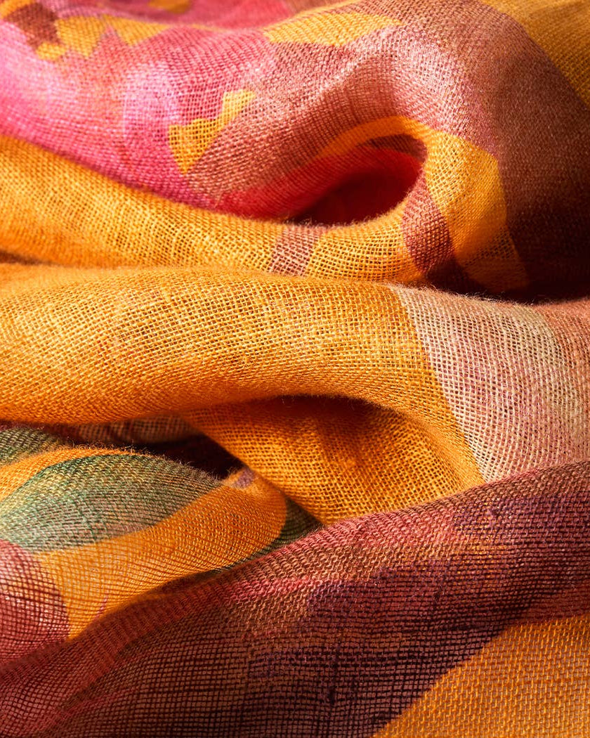 Close-up of colorful fabric with pink, yellow, and green patterns.