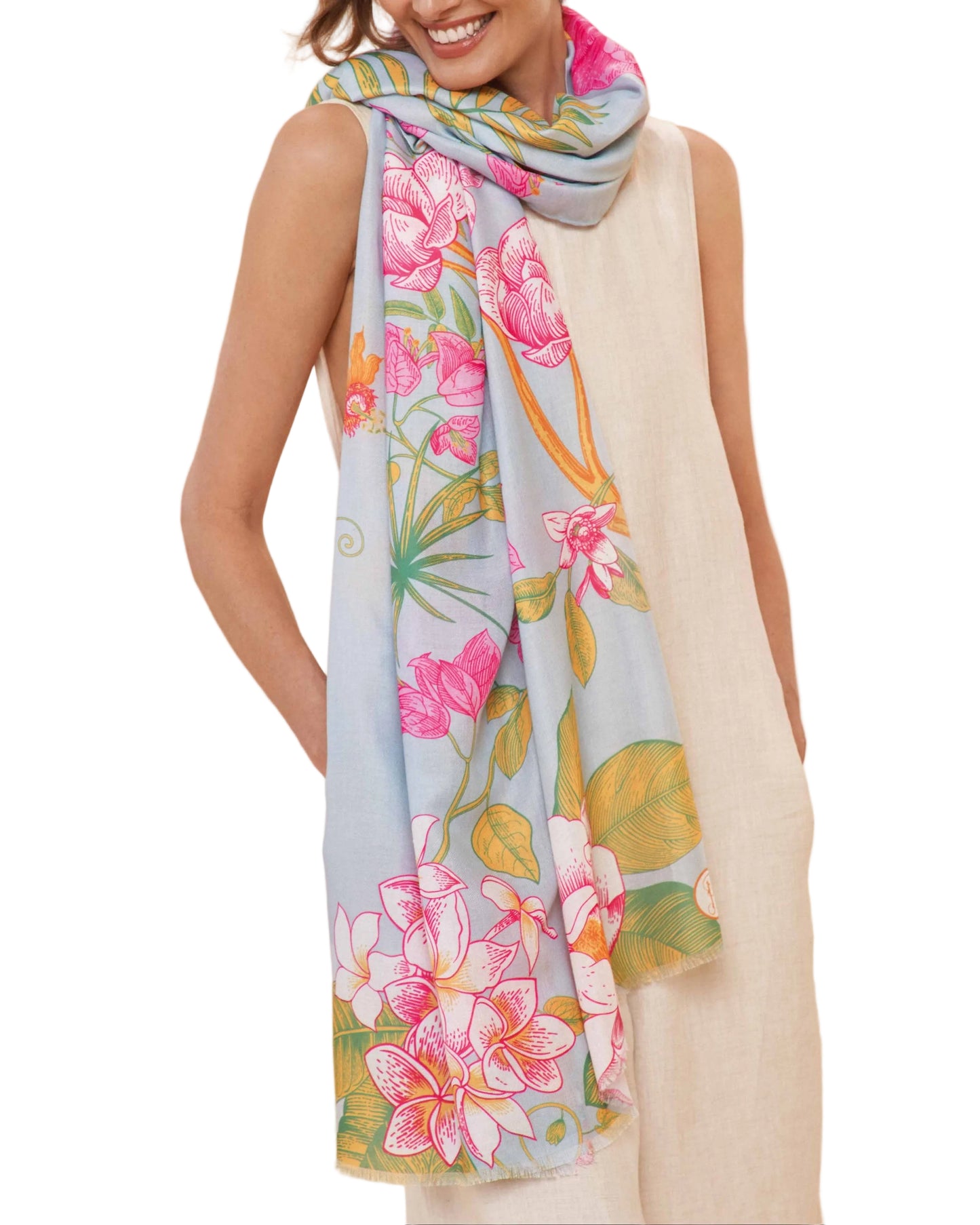 A woman wearing a floral jungle scarf in lavender and other light colors.