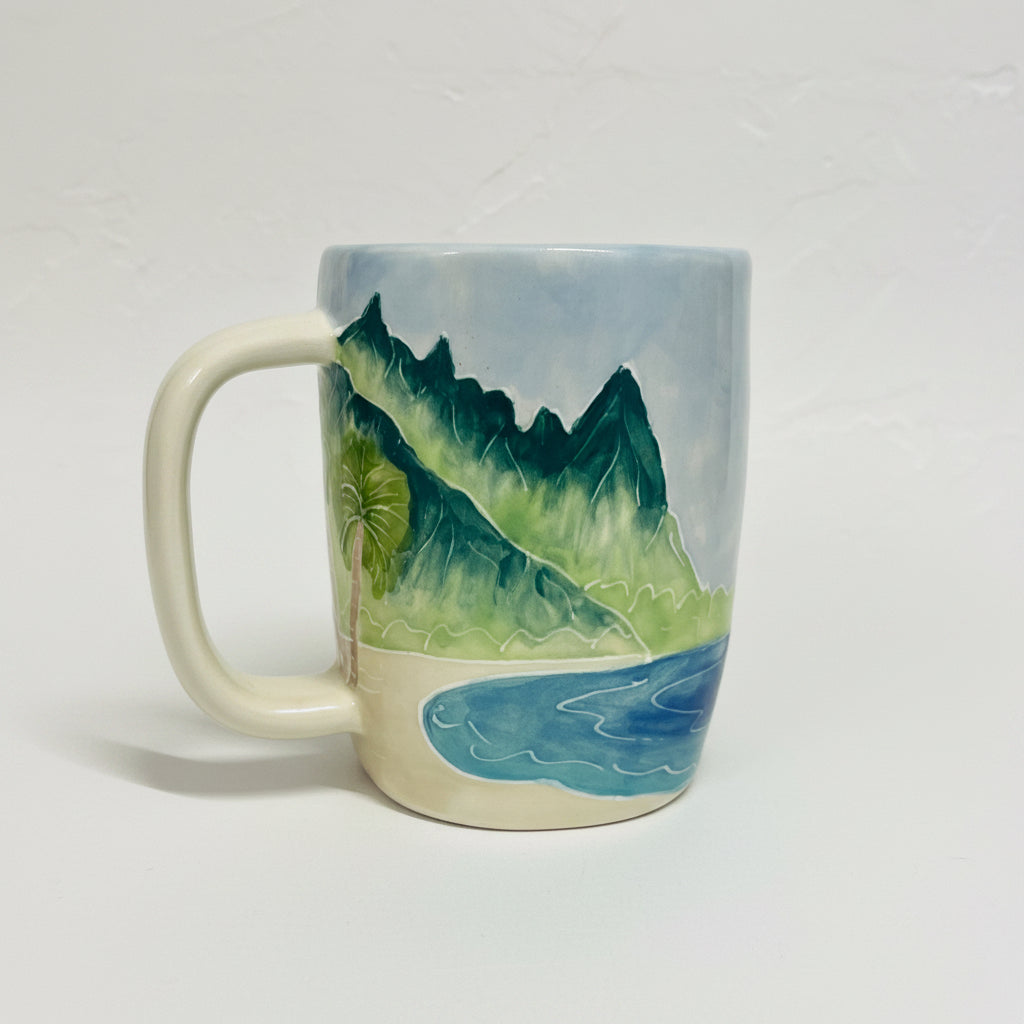 Hand painted mug on a plain background depicting mountain range "Bali Hai" from the north shore of Kauai