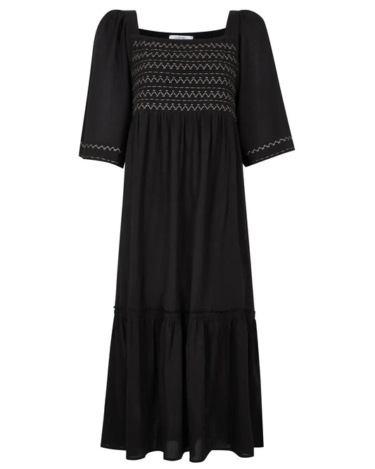 Black dress with embroidered details on a white background