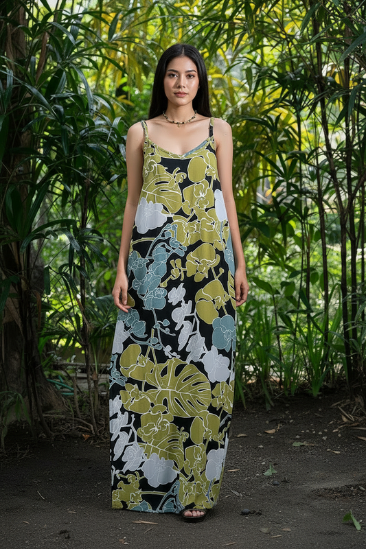 Woman wearing a floral dress standing in a lush green forest