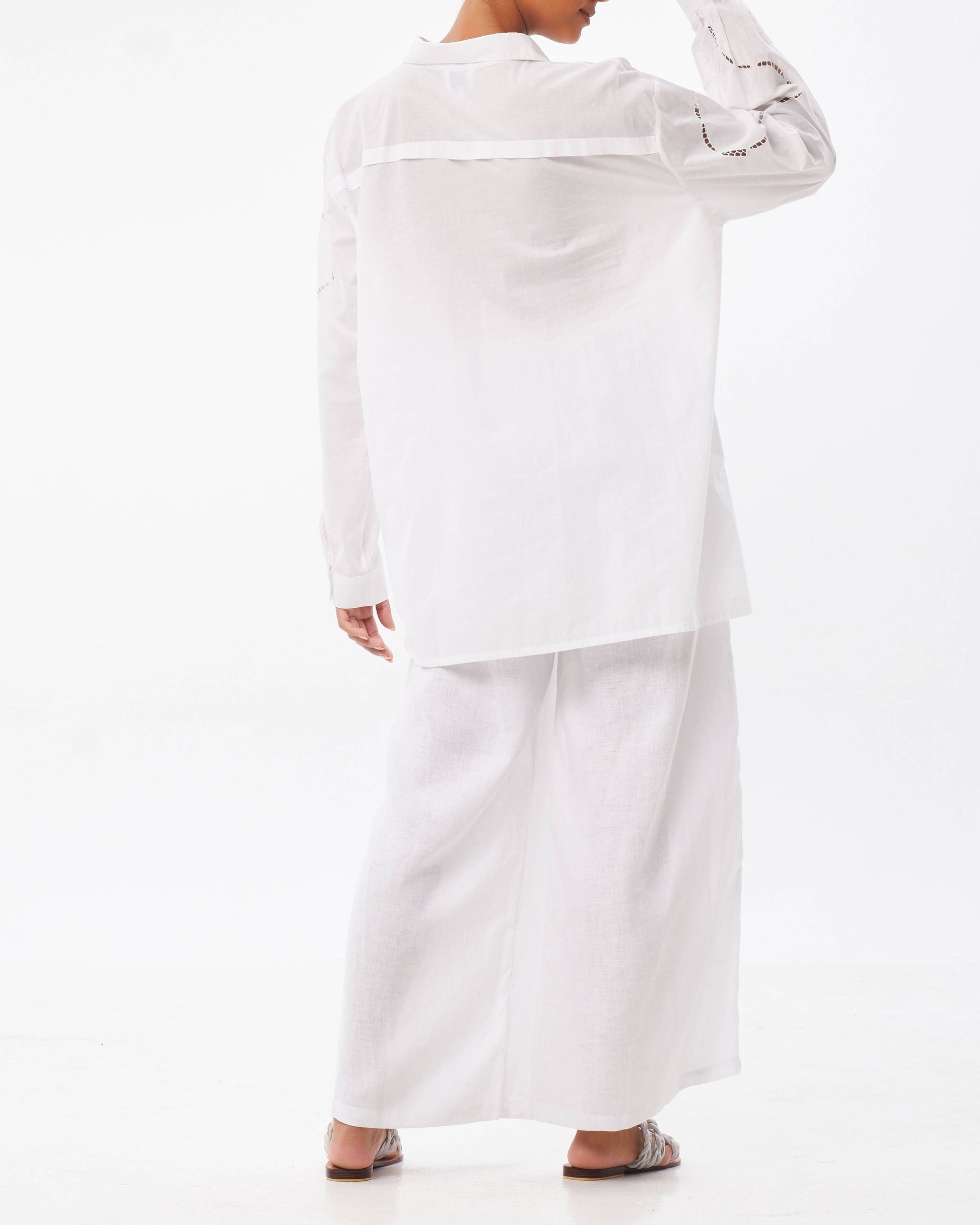 Person wearing a white outfit on a white background