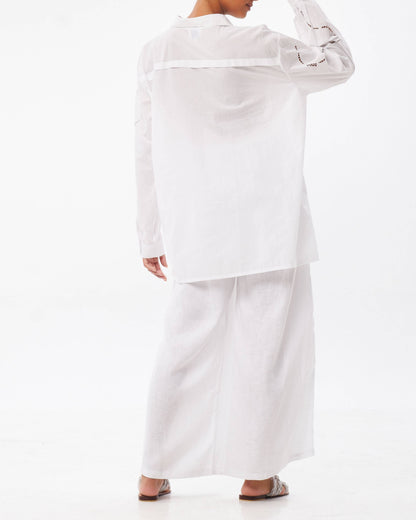 Person wearing a white outfit on a white background