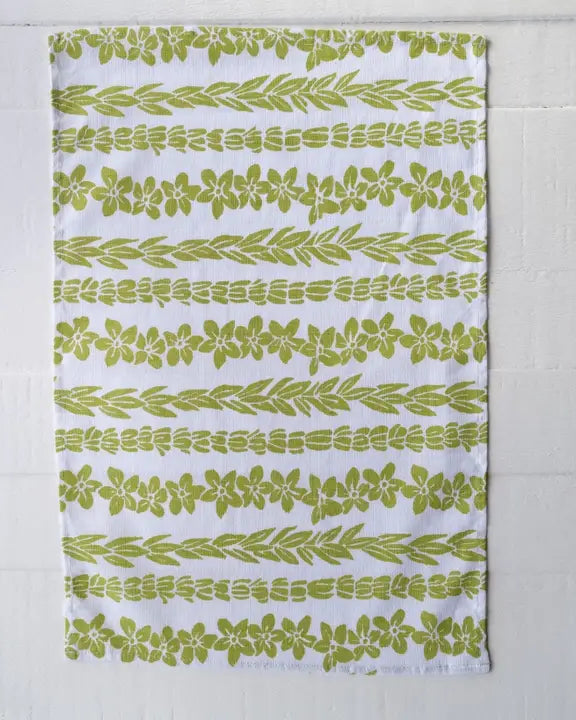 Green leaf patterned towel on a white background