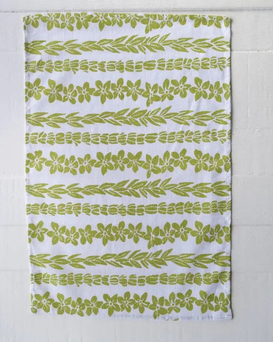 Green leaf patterned towel on a white background