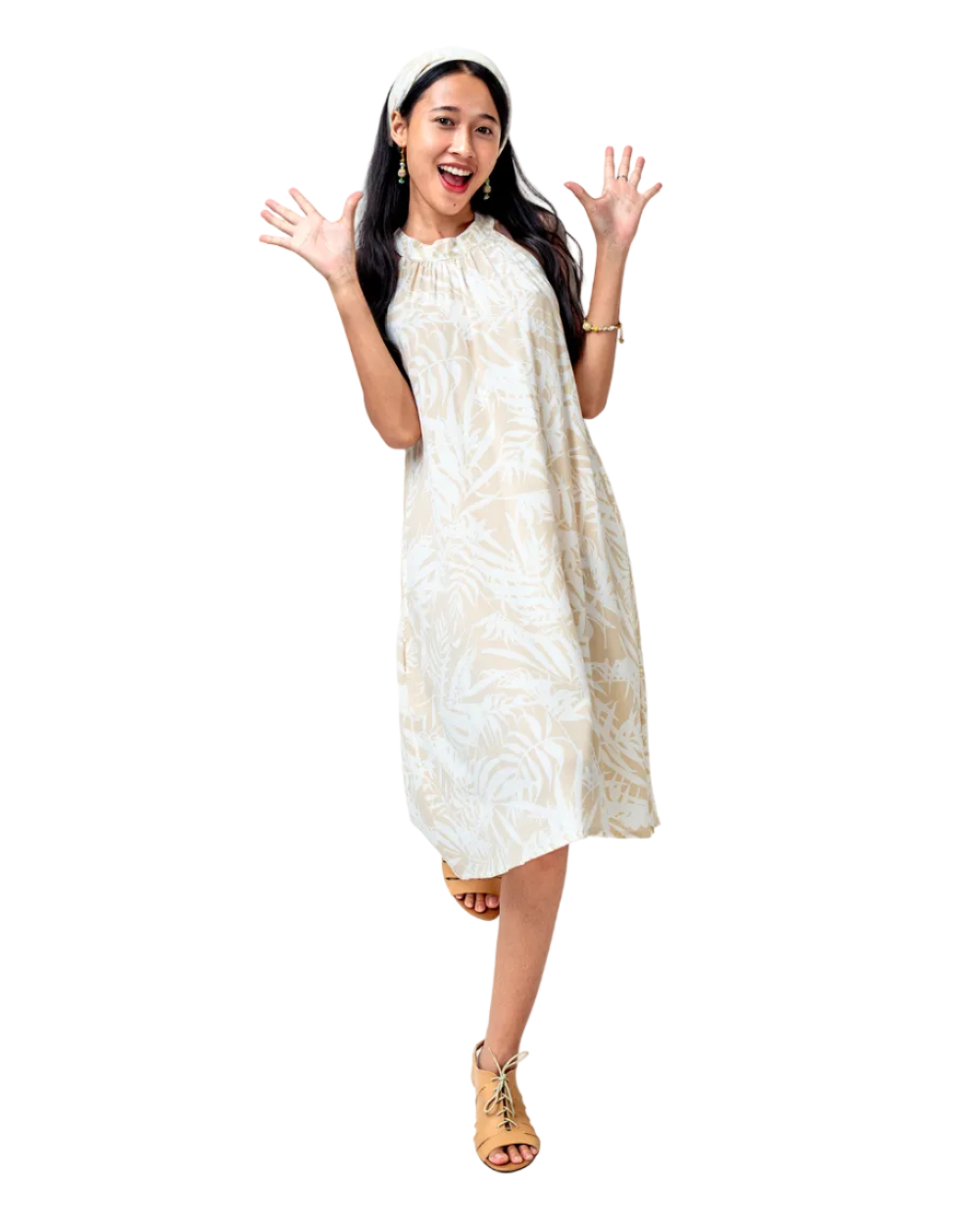 Woman wearing a white dress with a floral pattern on a white background