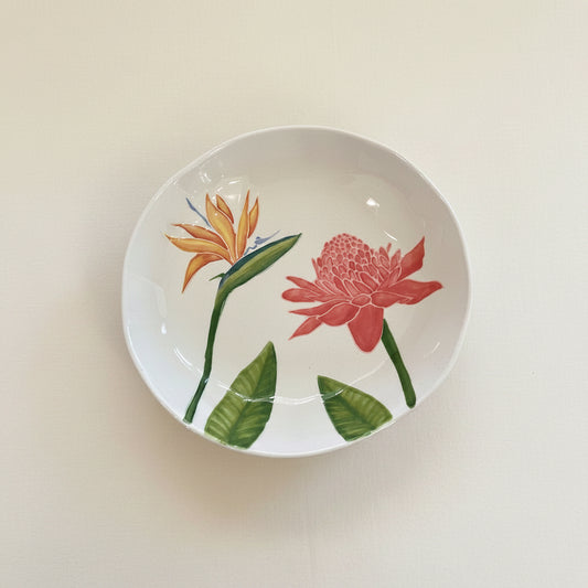 Ceramic bowl with tropical flower design on a white background