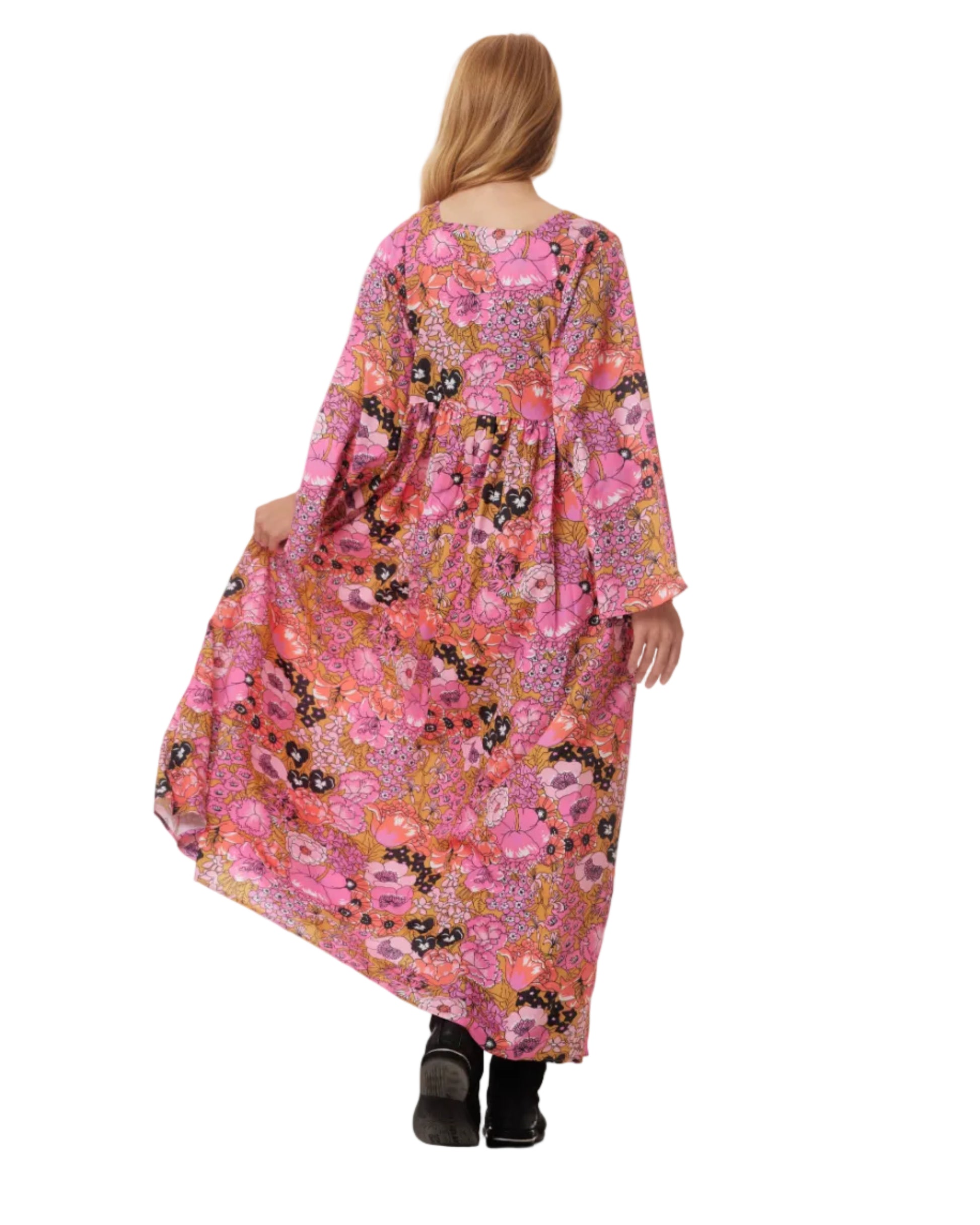 Woman wearing a long, floral-patterned dress on a white background