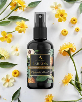 Bottle of pineapple and coconut-infused product surrounded by yellow flowers and green leaves on a white background