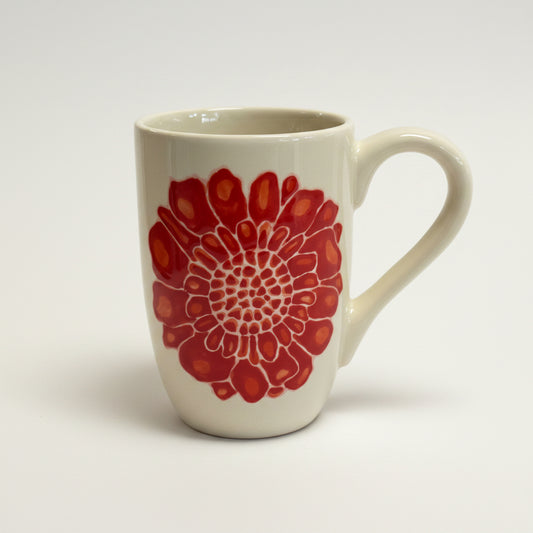White mug with red floral pattern on a white background