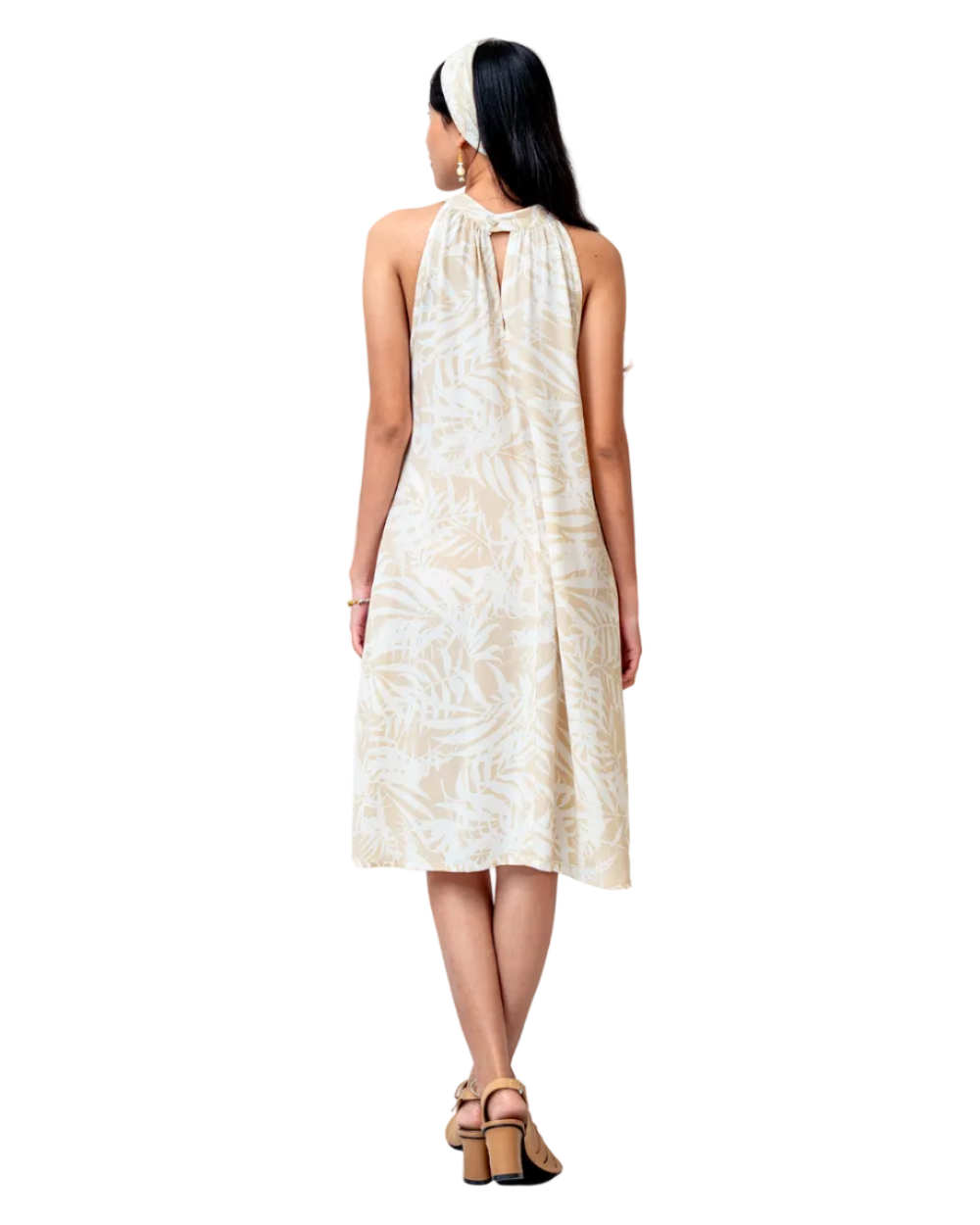 Woman wearing a white dress with a subtle pattern on a white background