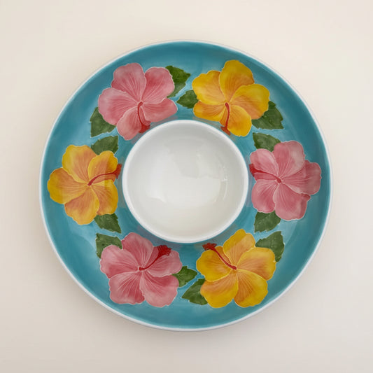 Decorative plate with floral design on a light fabric background