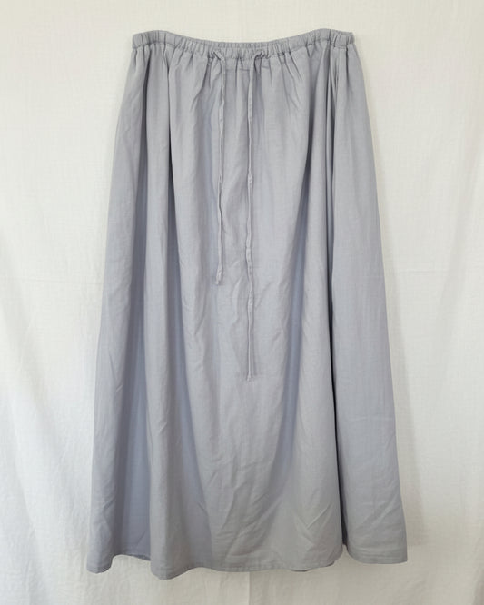 Gray skirt on a hanger against a white background