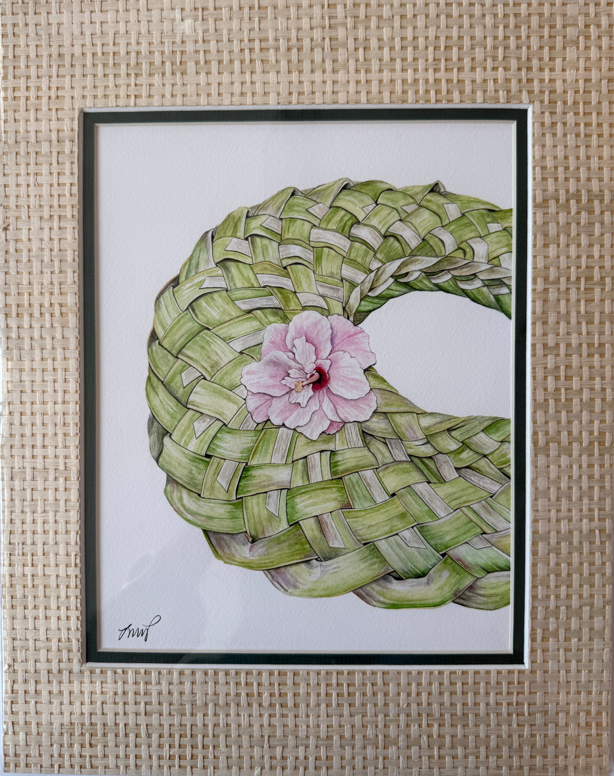 A framed art print featuring a hand-drawn illustration of a woven green coconut shell basket with a pink hibiscus flower in the center, set against a light background.