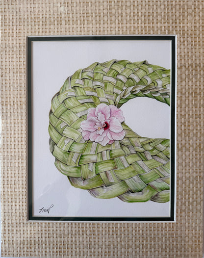 A framed art print featuring a hand-drawn illustration of a woven green coconut shell basket with a pink hibiscus flower in the center, set against a light background.