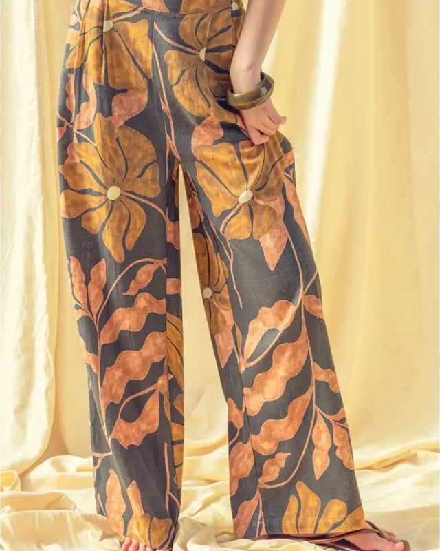 Person wearing a leaf-patterned outfit with a plain background