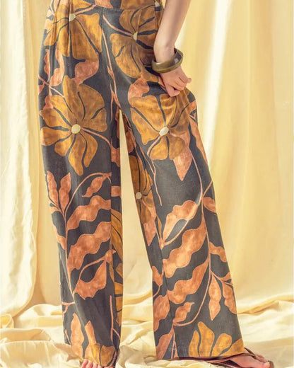 Person wearing a leaf-patterned outfit with a plain background