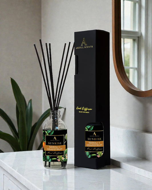 Diffuser with packaging on a marble surface with a plant and mirror in the background