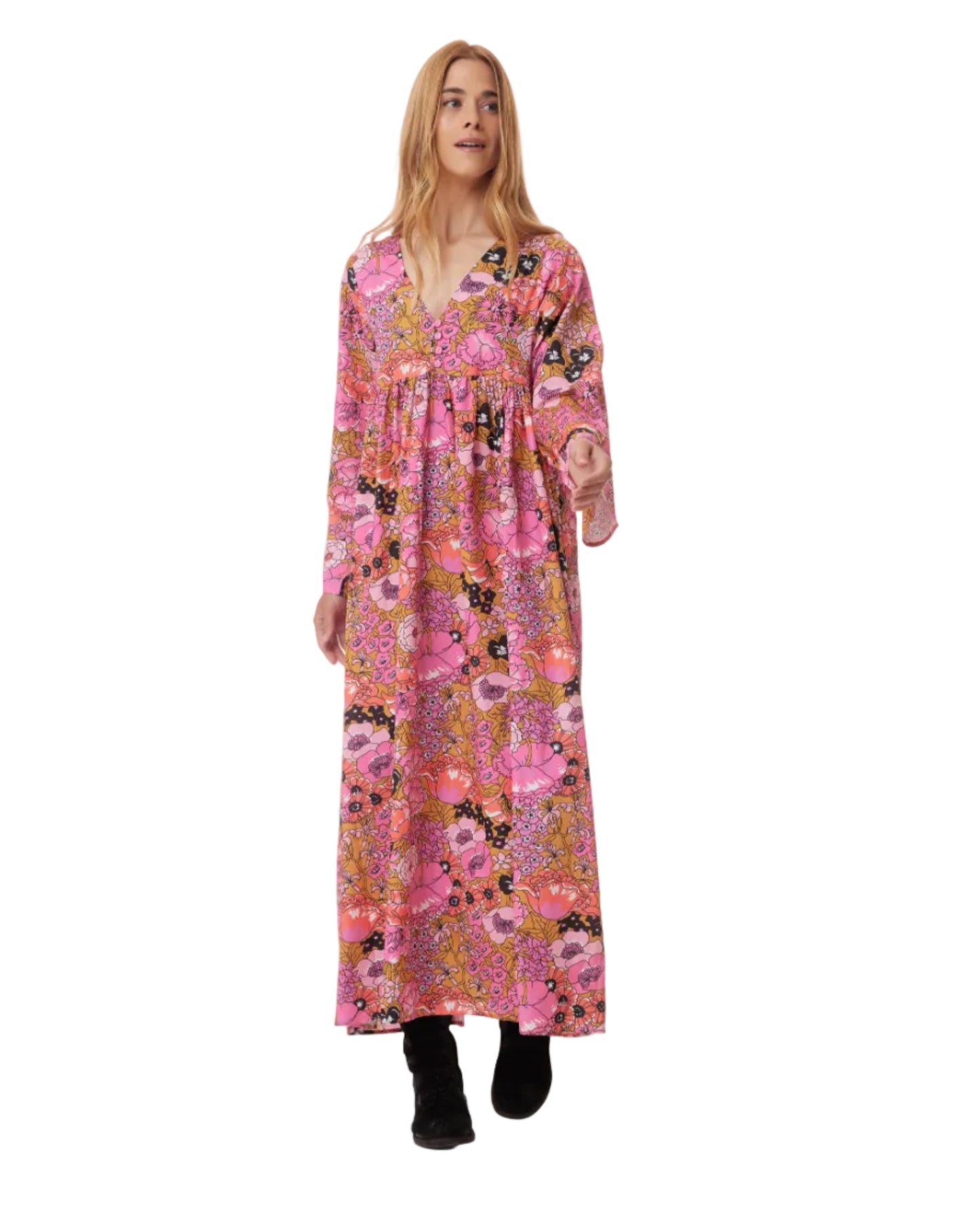 Woman wearing a long pink floral dress on a white background