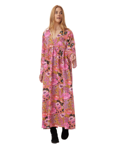 Woman wearing a long pink floral dress on a white background