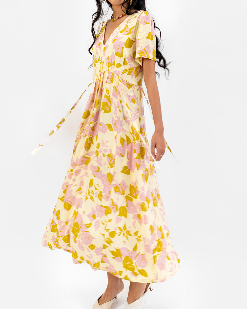 Woman wearing a floral dress on a white background